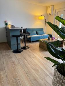 a living room with a blue couch and a table at Torrent House in Bouveret