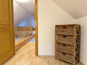 a room with a stack of baskets next to a door at Csendzug Vendégház in Békésszentandrás +26 photos