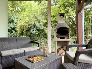 a chess board on a table in front of a fireplace at Csendzug Vendégház in Békésszentandrás