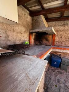 a room with a stone fireplace in a building at Casa Lucia in Villasimius