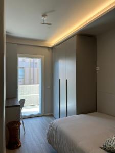 a bedroom with a large bed and a window at Brezza di mare home con garage in Civitanova Marche