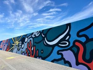 a wall with a painting on the side of it at Brezza di mare home con garage in Civitanova Marche
