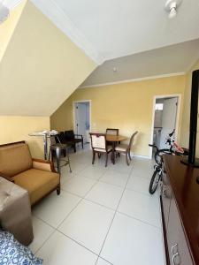 a living room with a couch and a table at Casa Silva enseada in Guarujá