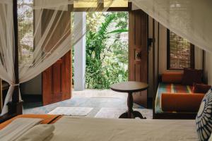 En eller flere senge i et værelse på My Home Villa