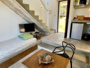 a room with a bed and a table and a staircase at Les Diablettes in Punta Del Diablo