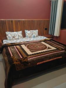 a bed in a room with a blanket on it at Hill Side Heaven Homestay in Nainital +5 photos