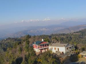 an aerial view of a house on a hill at Hill Side Heaven Homestay in Nainital