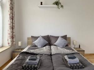 a bed with two pillows on it in a bedroom at Csendzug Vendégház in Békésszentandrás