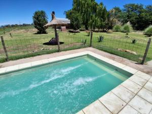 a swimming pool in a yard with a fence at CABAÑA NUESTRO HOGAR in San Rafael