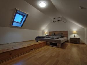 a large bedroom with a bed and a window at Csendzug Vendégház in Békésszentandrás