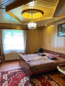 a dining room with a table and a chandelier at TaVa House 1 in Yaremche
