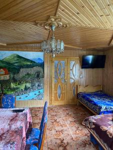 a bedroom with two beds and a chandelier at TaVa House 1 in Yaremche