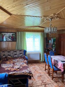 a bedroom with a bed and a table and chairs at TaVa House 1 in Yaremche