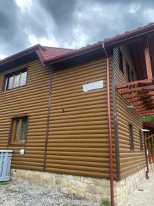 a wooden garage door on the side of a house at TaVa House 1 in Yaremche