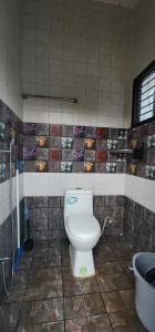 a bathroom with a toilet and a sink in it at LBS Farms in Coimbatore +13 photos