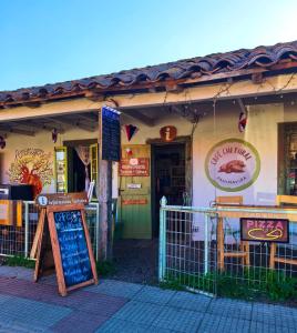 a restaurant with a sign in front of a building at Departamento Vintage in Colbún