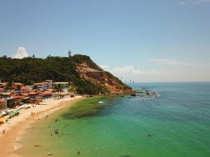 a beach with a bunch of people in the water at Casa Varandão, 1ª praia, Morro de São Paulo in Cairu