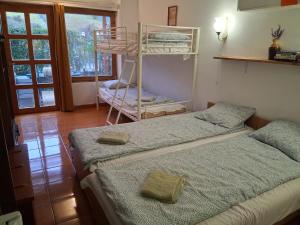 a bedroom with two beds and a bunk bed at Majestic Apartmanház Badacsony in Badacsonytomaj