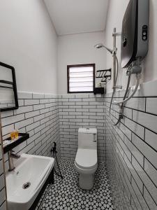 a bathroom with a white toilet and a sink at Tambun - Near LWOT, PLUS Highway Access ,Sunway & Pantai Hosp in Tambun +7 photos