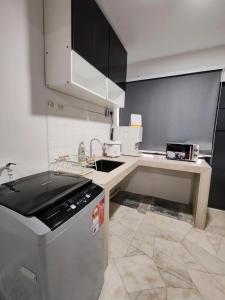a small kitchen with a sink and a dishwasher at Tambun - Near LWOT, PLUS Highway Access ,Sunway & Pantai Hosp in Tambun