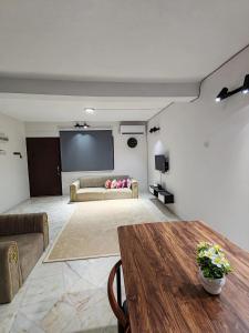 a living room with a couch and a projection screen at Tambun - Near LWOT, PLUS Highway Access ,Sunway & Pantai Hosp in Tambun