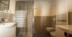 a bathroom with a shower and a toilet and a sink at Albergo Covili in Pavullo nel Frignano +63 photos