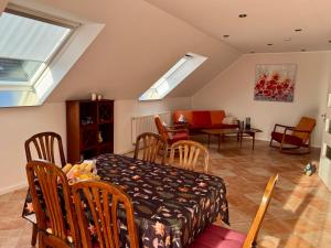 a room with a table and chairs and a dining room at Eifeleule in Hürtgenwald