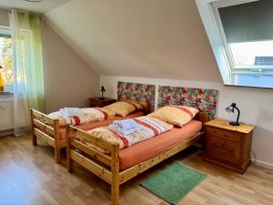 a bedroom with two beds and a window at Eifeleule in Hürtgenwald