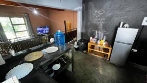 a kitchen with a sink and a refrigerator at Zoko cottage in Maun
