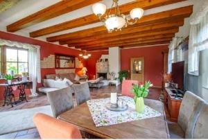 a living room with a dining table and a living room at Landhaus Nadine in Kolonie Roeske