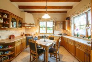 a large kitchen with a table and chairs in it at Landhaus Nadine in Kolonie Roeske