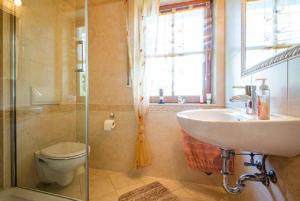 a bathroom with a sink and a toilet and a shower at Landhaus Nadine in Kolonie Roeske +6 photos