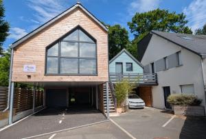 a house with a garage in a parking lot at Résidence Chez Gally in Les Ponts-de-Cé