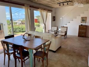 a living room with a table and a couch at Les Diablettes in Punta Del Diablo