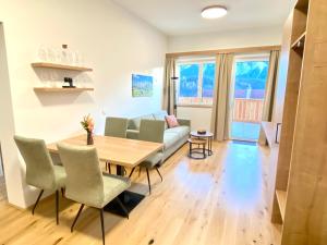a living room with a table and chairs and a couch at Grimming View I - Zentral in Tauplitz, Nahe Sessellift, Bergblick & Parkplatz in Tauplitz