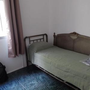 a bed sitting in a room next to a window at La Olimareña in Treinta y Tres +4 photos