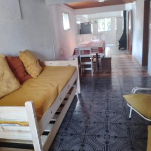 a room with a bed and a dining room with a table at La Olimareña in Treinta y Tres