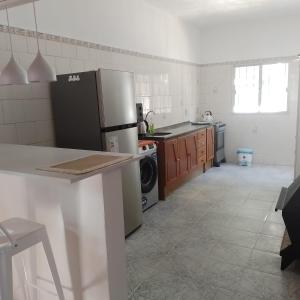 a kitchen with a refrigerator and a dishwasher at La Olimareña in Treinta y Tres