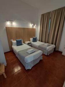 En eller flere senge i et værelse på Sabbia Suites El Muellito