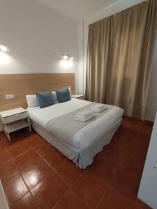 En eller flere senge i et værelse på Sabbia Suites El Muellito + 3 billeder