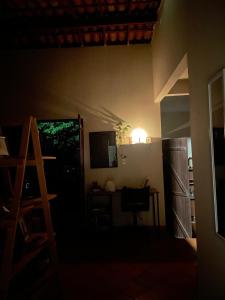 a dark room with a desk and a table with a light at Casa Kahlo in Lençóis