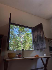 a window in a kitchen with a tree at Casa Kahlo in Lençóis