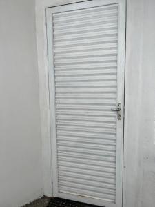 a metal garage door in the side of a building at Suíte privativa in Boa Vista