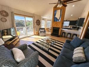 a living room with a blue couch and a fireplace at D112-Happy Go Ducky in Duck