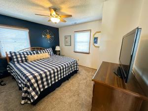 a bedroom with a bed and a flat screen tv at D112-Happy Go Ducky in Duck +30 photos