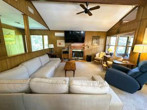 a living room with a white couch and a ceiling fan at SS303- Duck Hill in Southern Shores