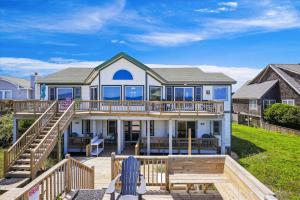 a large house with a deck and stairs at SS3 - Bella Luna in Southern Shores