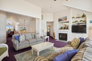 a living room with couches and a fireplace at SS3 - Bella Luna in Southern Shores