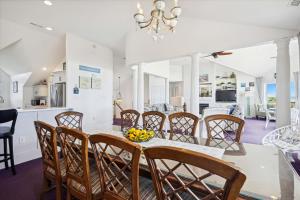 a dining room and kitchen with a table and chairs at SS3 - Bella Luna in Southern Shores