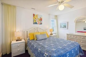 a bedroom with a bed and a ceiling fan at SS3 - Bella Luna in Southern Shores